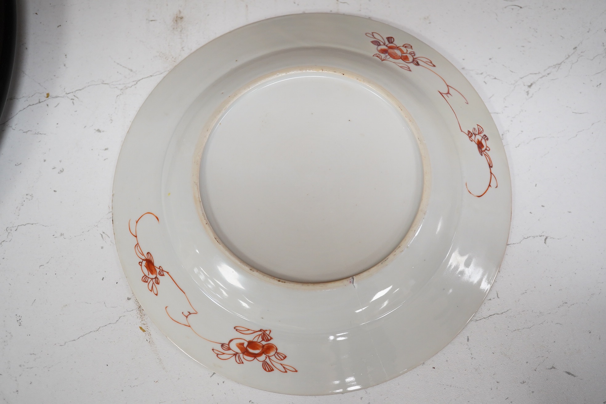 A Chinese iron-red ‘sanduo’ dish, 19th century and a Chinese famille rose plate, Yongzheng. famille rose plate 22.5cm diameter. Condition - poor to fair